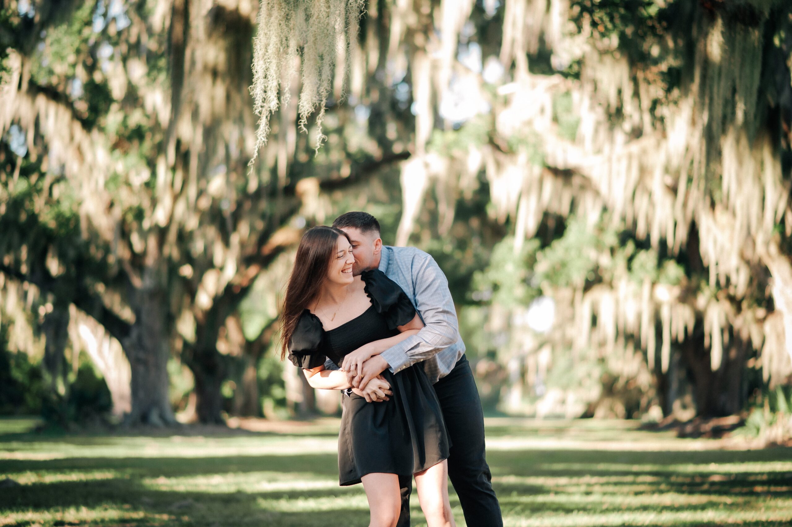 Engaged couple posing naturally and confidently at Fontainebleau State Park, Louisiana during their engagement photo session.