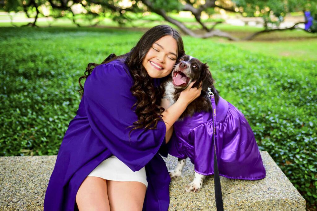 LSU senior posing with her dog during senior portraits on LSU campus in Baton Rouge, Louisiana