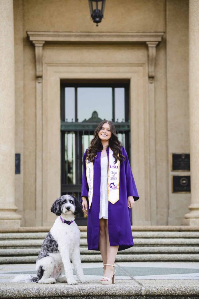 LSU senior posing with her dog during senior portraits on LSU campus in Baton Rouge, Louisiana