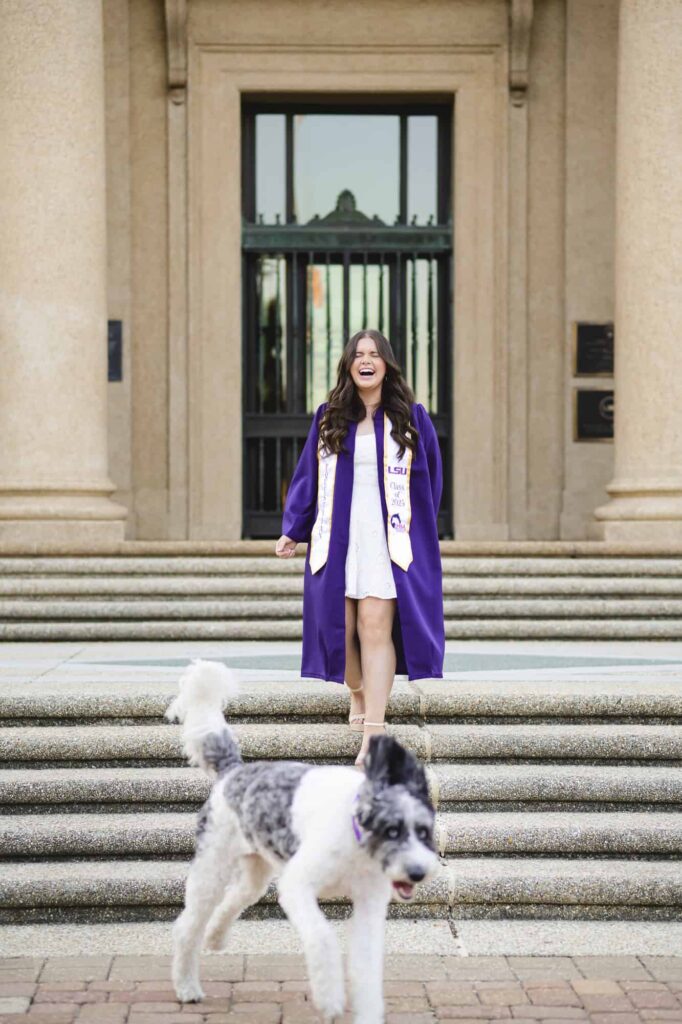 LSU senior posing with her dog during senior portraits on LSU campus in Baton Rouge, Louisiana