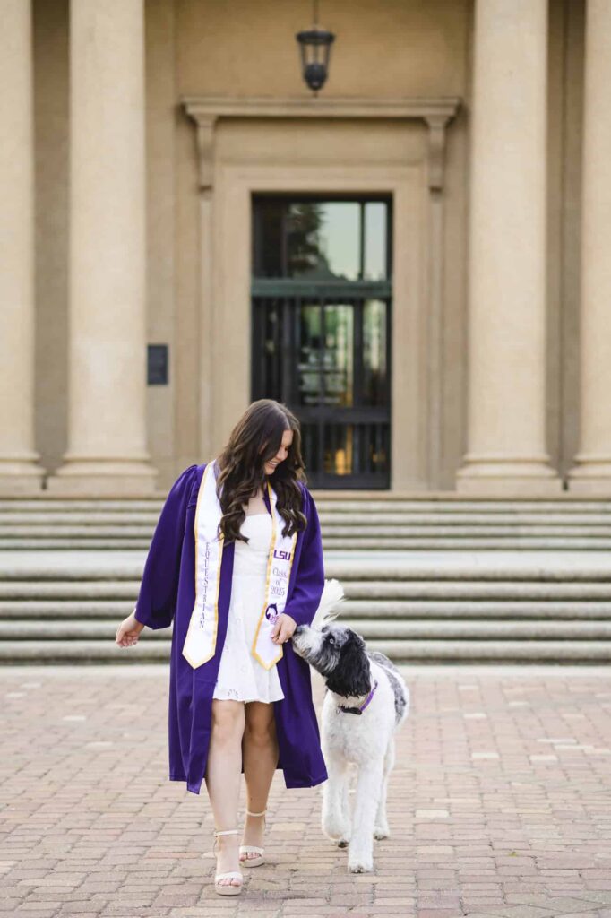 LSU senior posing with her dog during senior portraits on LSU campus in Baton Rouge, Louisiana