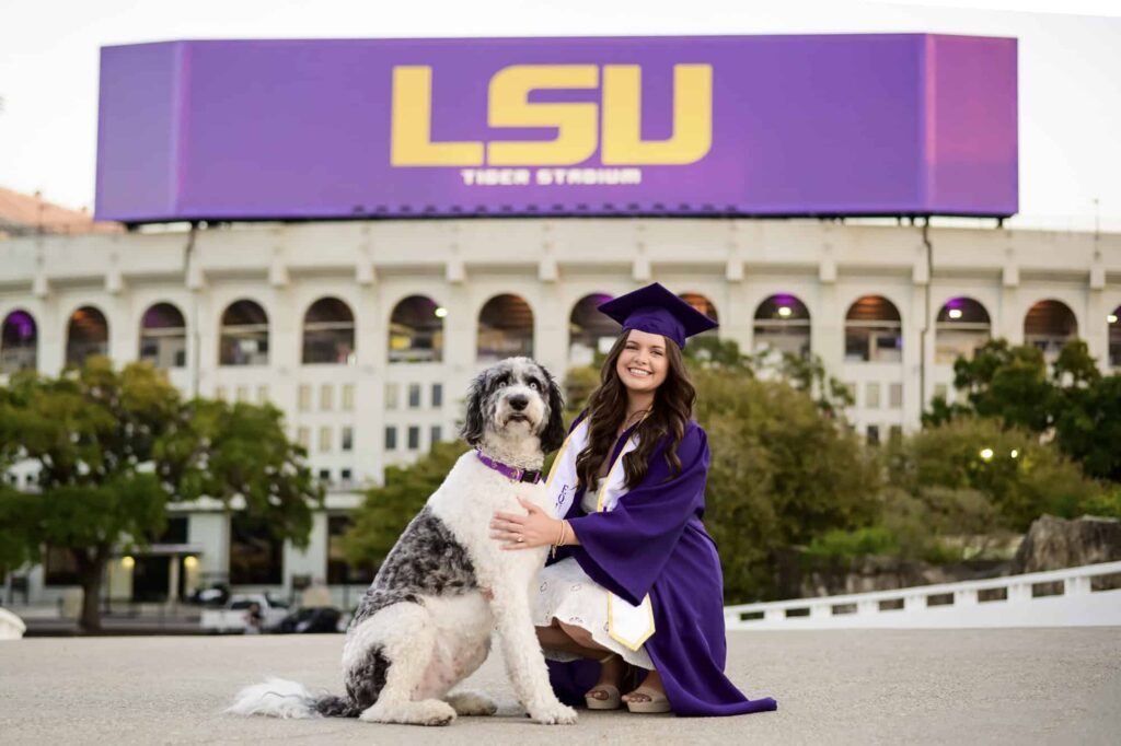 LSU senior posing with her dog during senior portraits on LSU campus in Baton Rouge, Louisiana