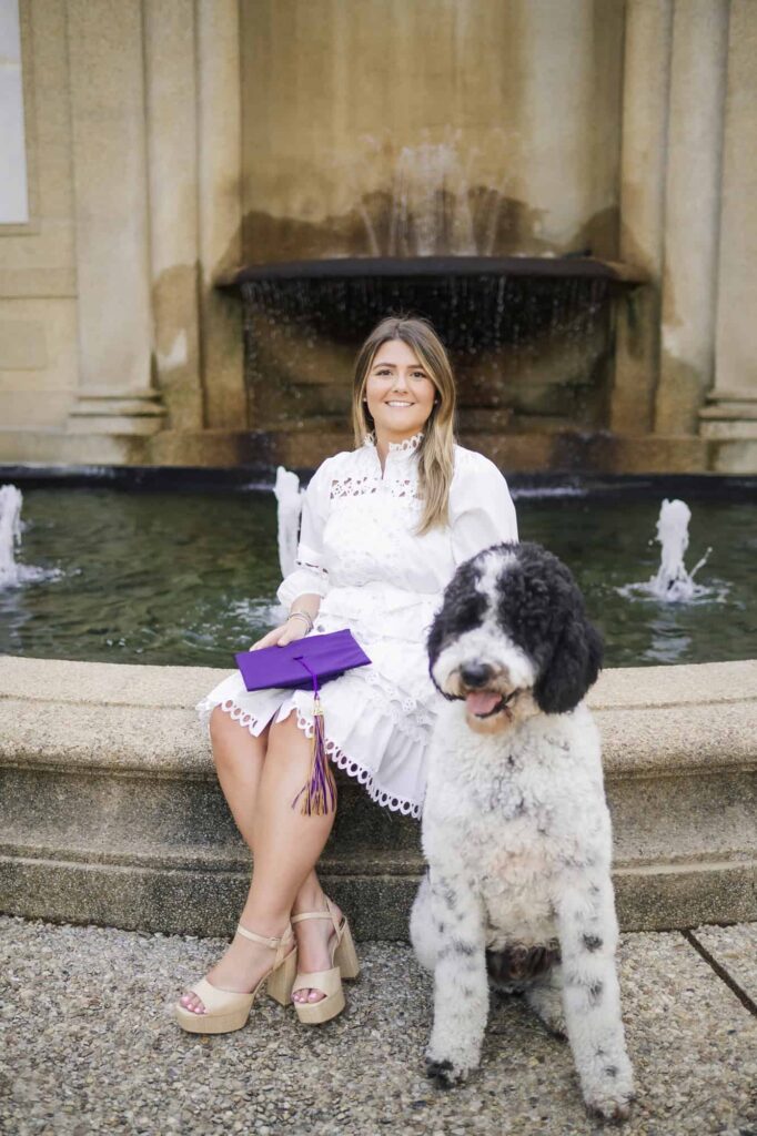 LSU senior posing with her dog during senior portraits on LSU campus in Baton Rouge, Louisiana
