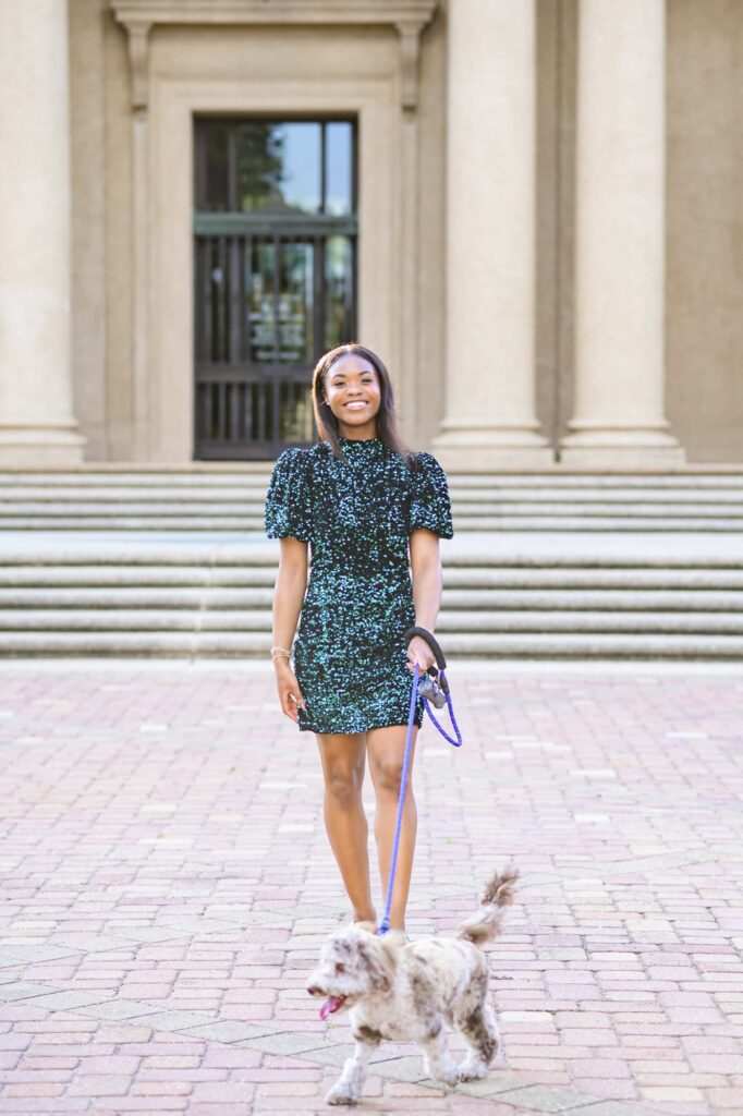 LSU senior posing with her dog during senior portraits on LSU campus in Baton Rouge, Louisiana