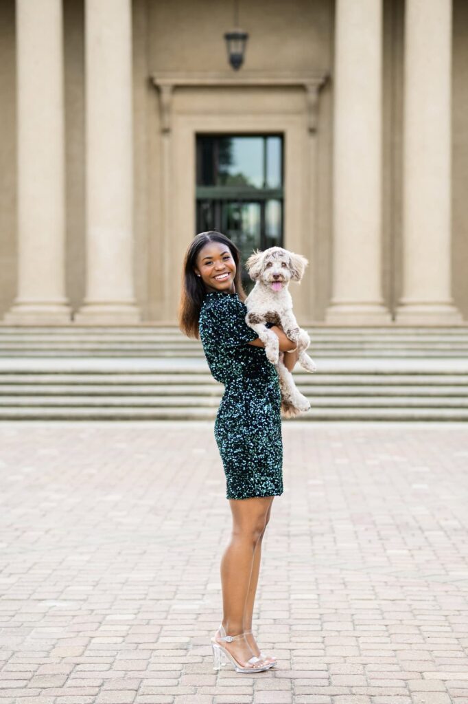 LSU senior posing with her dog during senior portraits on LSU campus in Baton Rouge, Louisiana