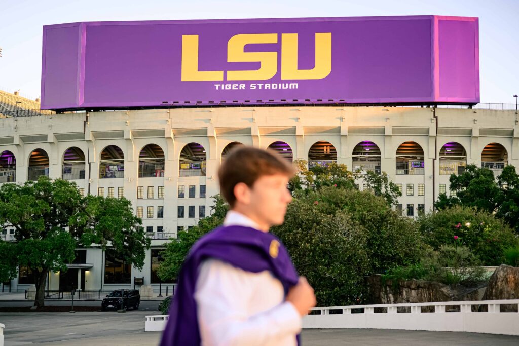 LSU senior poses at the PMAC during graduation portraits on LSU campus in Baton Rouge, Louisiana